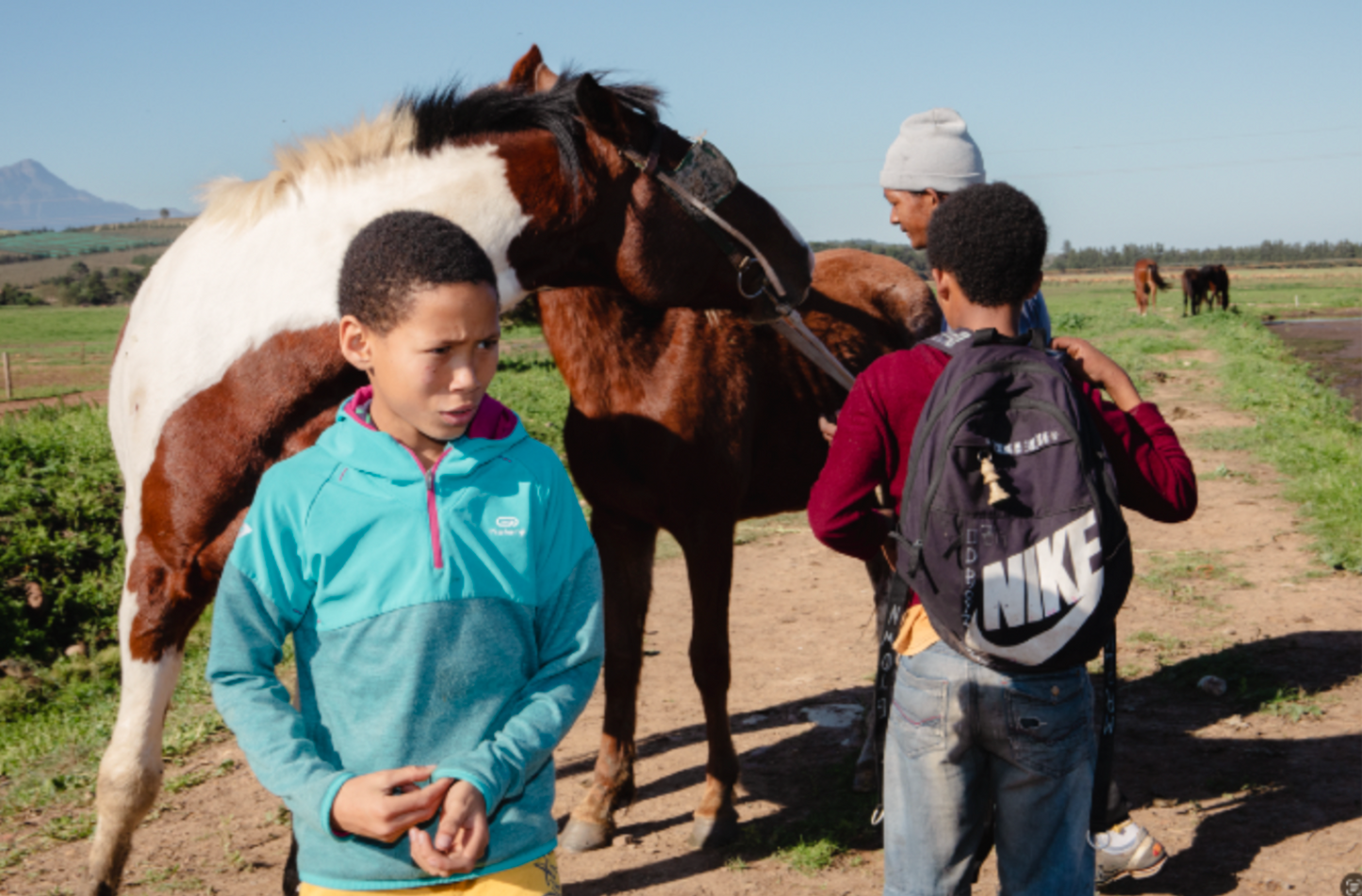 Tyrique Muller, Elnaldo Jafta and Matthew Plaatjies with Stallion and Queenie. Greyton