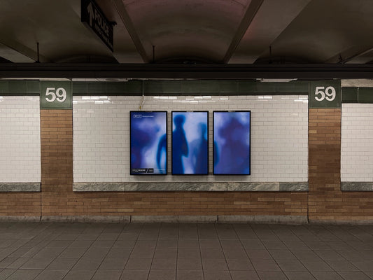 An empty subway featuring a digital billboard with a purple painting by Craig Cameron Mackintosh